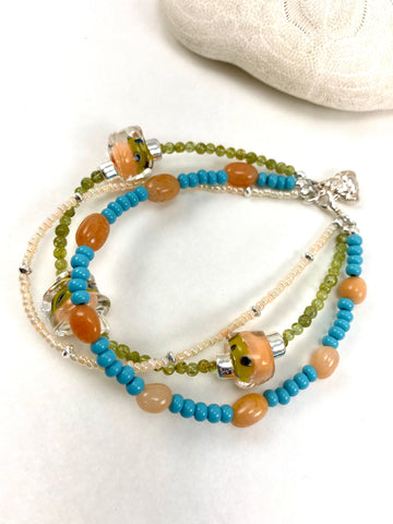 Three Strand Peach and Blue Beaded Bracelet with Buddha Charm